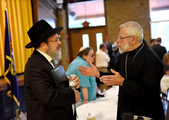 Bishop Libasci talks with faithful peers after panel discussion